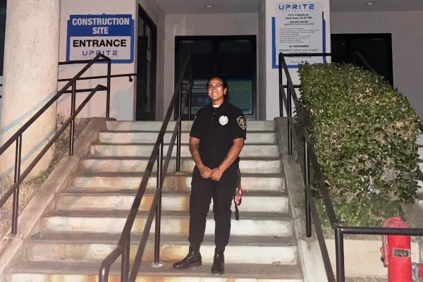 security guard Leo posing in front of a construction site